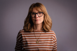 Woman wearing brown striped shirt